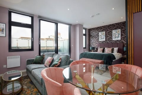 Integrated living, bedroom, and kitchen spaces in an open layout.