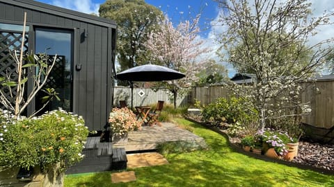 Cabin exterior with private garden and deck area (Spring time).
