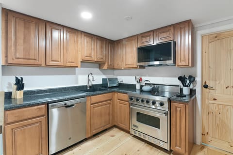 Main level kitchen with stainless steel appliances and stocked with essentials