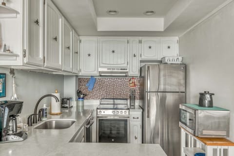 Functional kitchen providing essential appliances creating a clean and practical cooking space.