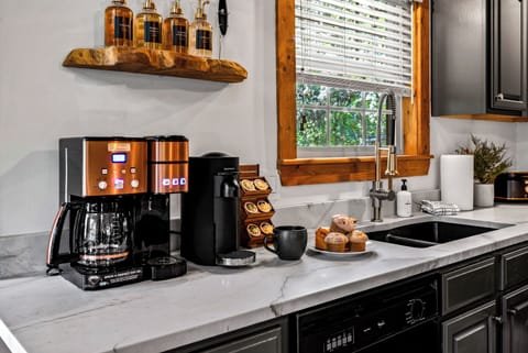 Indulge in our coffee bar featuring Nespresso, Keurig, French Press, and Drip coffee makers, along with flavored syrups for the ultimate experience