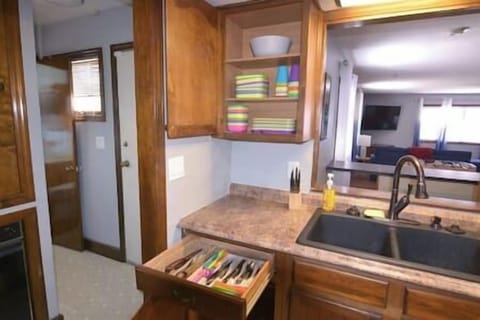 Kids plates and mixing bowl left of kitchen sink