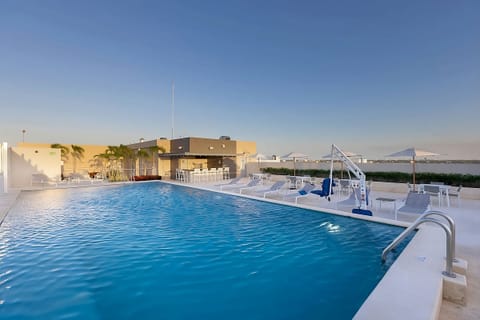 Soak up sunshine beside the expansive sparkling rooftop pool.