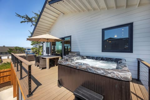 Spacious deck with hot tub, BBQ, firepit and outdoor dining.