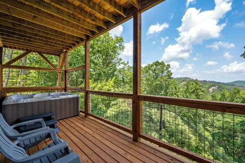 Downstairs covered porch with 5-person hot tub