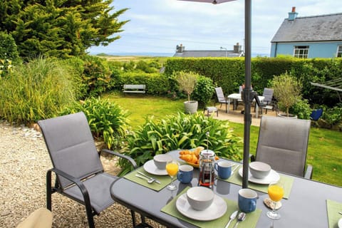 Patio area with lawn and distant sea views