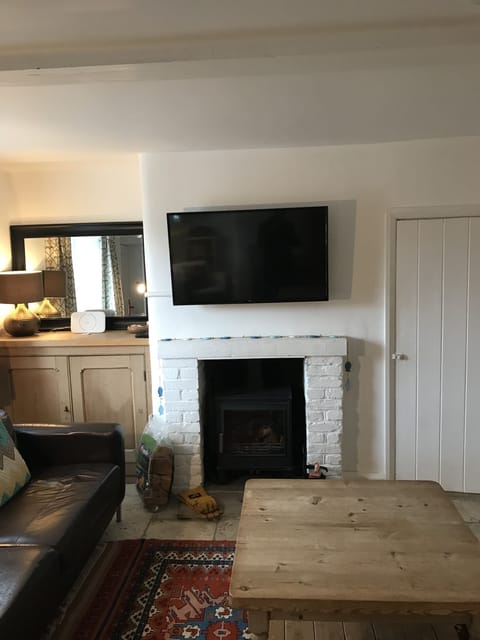 Living room with fireplace and large flatscreen TV