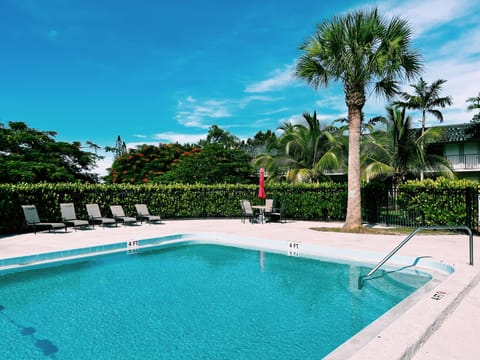 Our large communal pool open from sunset to sundown. The pool is filled with dining areas and lounge chairs to catch Florida's famous sun.
