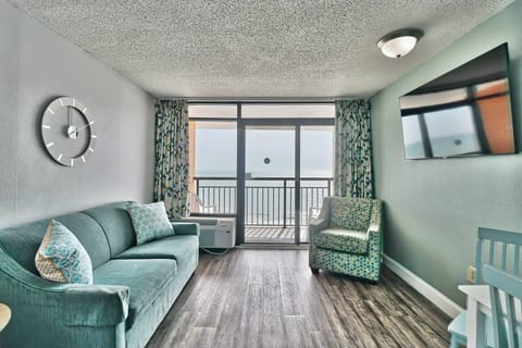 Embrace the serene ambiance of the oceanfront living area, where comfortable seating invites you to unwind while taking in panoramic views of the sea.