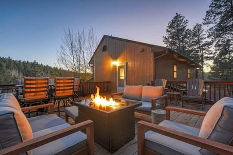 back porch has a gas firepit with chairs for 5 guests.