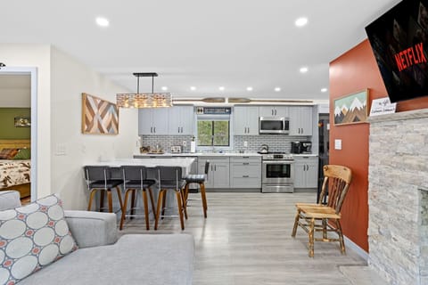 Cook like a pro in this sleek, fully stocked kitchen featuring stainless steel appliances, stylish gray cabinetry, and an inviting island with bar seating, great for morning coffee or evening cocktails.