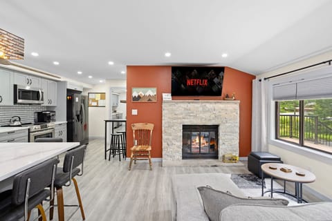 Gather around the fireplace in this beautifully designed living room. With a large TV for movie nights, a comfortable sectional, and an open flow to the kitchen, it’s the perfect space to relax and unwind.