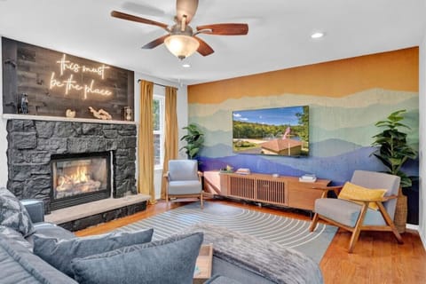 Cozy Comfort: Gather Around the Fireplace in Our Inviting Living Room with Ceiling Fan Ambiance  #HomeAwayFromHome #CozyVibes