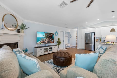 The living area is designed to be a sanctuary of relaxation and style, featuring comfortable, plush couches that invite you to unwind and enjoy.