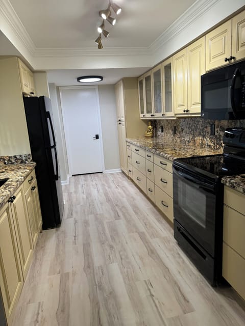 Large kitchen, stocked for home cooking. counter space! 
Laundry room entrance
