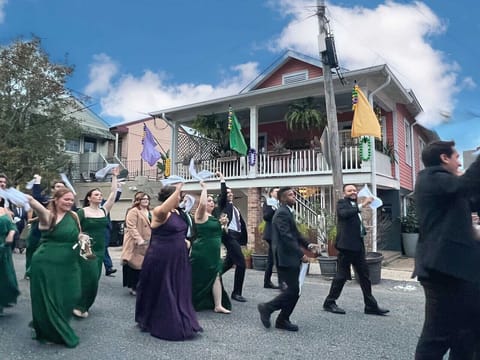 A front-row view of authentic New Orleans culture! Our spacious front porch overlooking a charming neighborhood moment, where second lines occasionally pass by, adding color, music, and unmistakable local character!