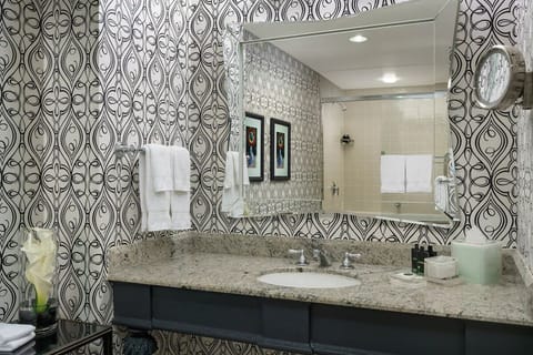 Refresh at a spacious granite vanity with bright, flattering light.