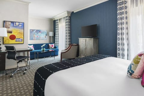 Stretch out with a cozy lounge corner and in-room workspace.