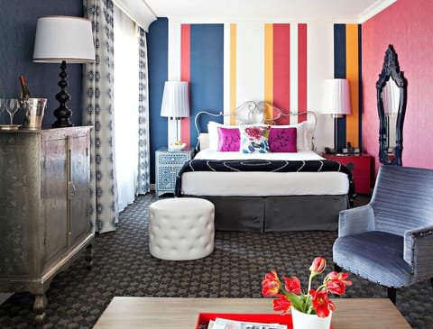 Unwind in a vibrant king room with bold designer flair.