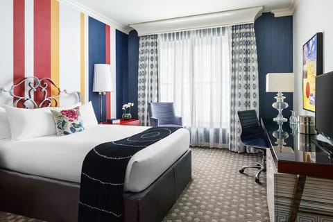 Wake up to soft daylight beside a sleek, practical workspace.