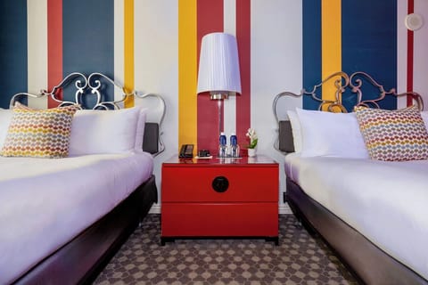 Settle into double beds with crisp linens and playful colors.
