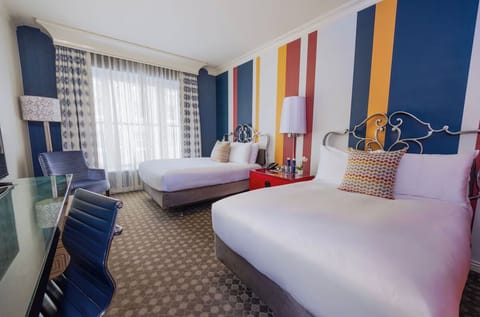 Settle into double beds with crisp linens and playful colors.