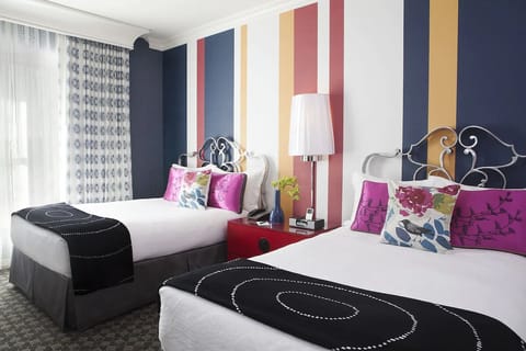 Settle into double beds with crisp linens and playful colors.