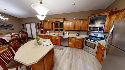 Full kitchen with stainless steel appliances, gas range, and large center island