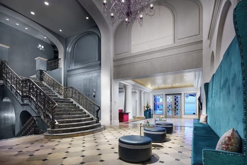 Wander through an elegant lobby with sweeping staircase drama.