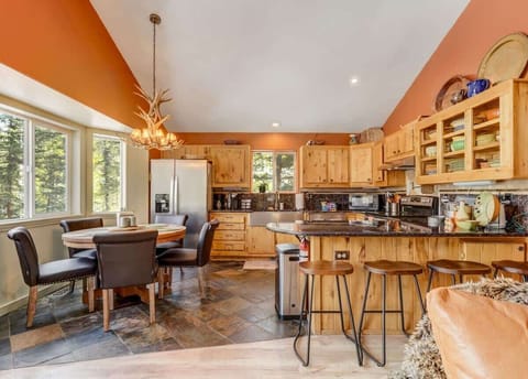 Dine with a view! Our kitchen and dining space opens up to the beauty of the pines, creating the perfect backdrop for your nature feasts.