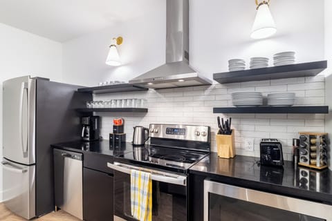 Fully equipped kitchen with stainless steel appliances.