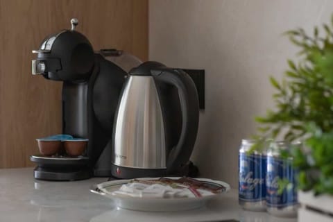 A close-up of a coffee corner with a modern machine and greenery. Great for morning routines.
