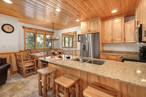 Timber Wolf Lodge 10 D has an a breakfast bar in the kitchen with seating for 3 on wooden stools.