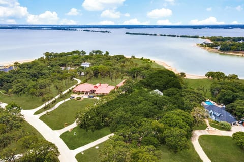 This sprawling vacation estate is sure to impress with its swimming pool oasis, tranquil backyard trees, and spacious layout! This place is a dream for anyone looking for lakeside living!