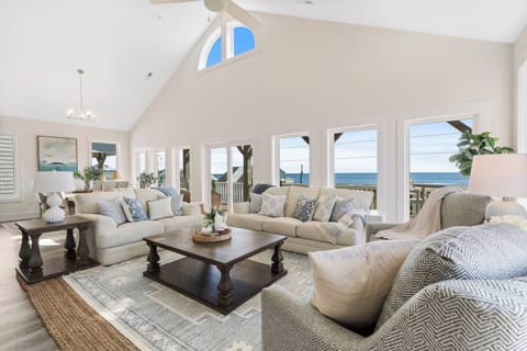 Stunning ocean-view living room, bright and airy with plush seating.