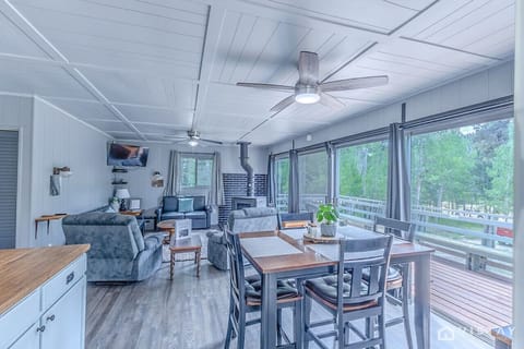 Escape to our charming cabin nestled in nature, featuring a spacious open-concept living, dining, and kitchen area.