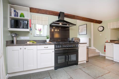 The kitchen with an electric range oven and gas hob