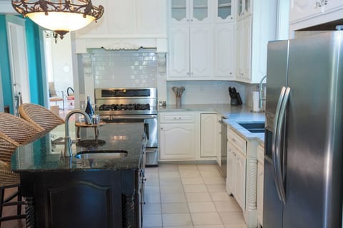 Full kitchen with Ice maker and water dispenser on fridge.