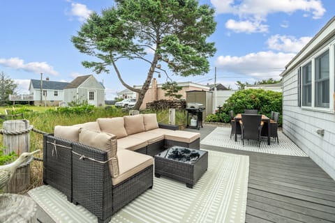 Back deck with spacious outdoor section, 6-person outdoor dining table, gas grill, and ocean views!