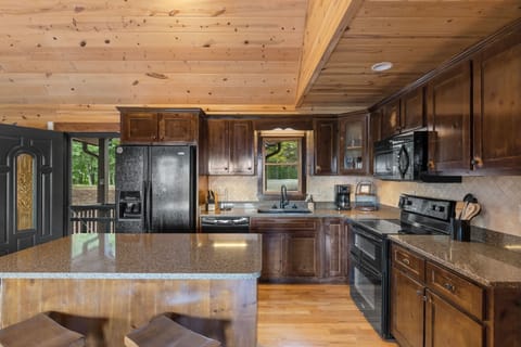 Our fully stocked kitchen, where rustic charm meets modern convenience for a delightful cooking experience.