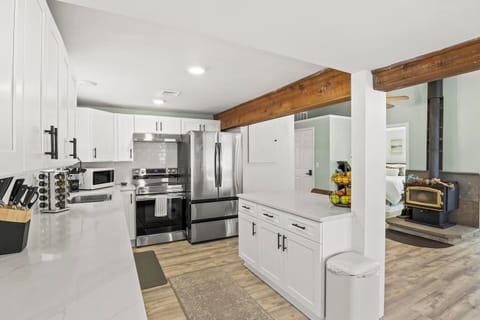 Modern kitchen with stainless steel appliances and ample counter space, perfect for preparing meals during your stay in Honeoye, NY. 
