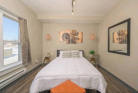 Industrial decor and a queen bed complete this bedroom overlooking downtown.