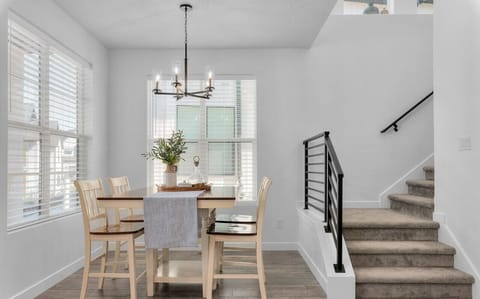 The open dining area seamlessly blends into a minimalist dining area