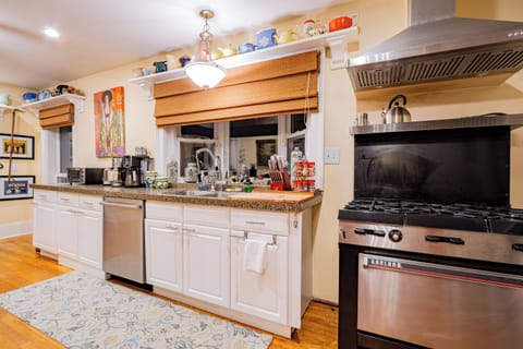 Large kitchen with commercial Garland Stove and pot filler. 