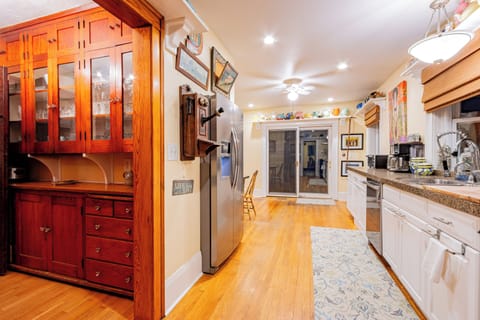 The butler's pantry is just off the kitchen stocked with plenty of dinnerware.