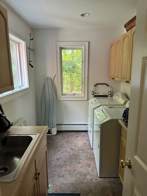 First floor laundry room - washer/dryer, ironing board, iron, drying rack, etc. 