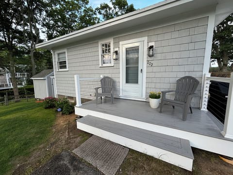 Watch neighbors out for a walk or on their way to the beach on this front porch!