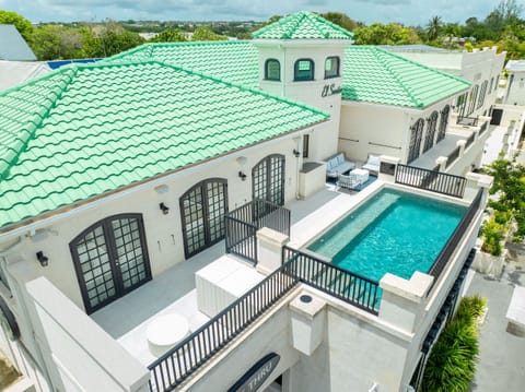 Rooftop pool, terrace and two seating areas.