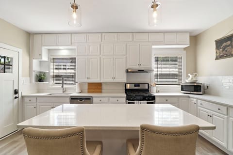 Open concept kitchen in lower unit includes breakfast bar