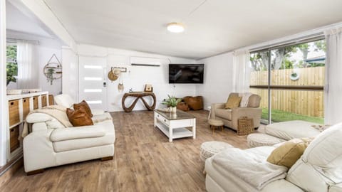Relax in the large open plan living room with Smart TV and comfortable lounges